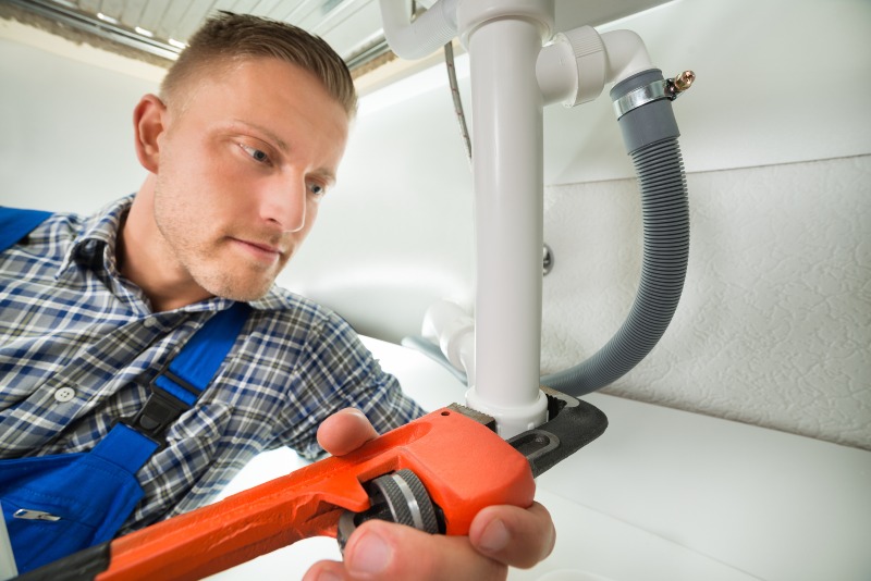 Technician Performing Backflow Testing & Replacement in Jacksonville, FL, Ensuring Safe Water Supply