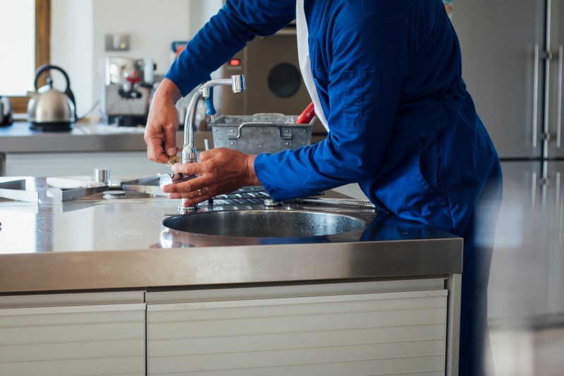 Expert Plumber Repairing a Faucet in Jacksonville, FL, Demonstrating Quality Faucet Repair Services